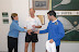 Kate awards Mike his trophies
