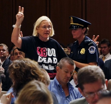 Retired Army Col. Ann Wright is removed by Capitol Hill Police on Capitol Hill in Washington, Tuesday, Sept. 11, 2007, as Gen. David Petraeus and U.S. Ambassador to Iraq Ryan Crocker testified on the future course of the war in Iraq before the Senate Foreign Relations Committee. (AP Photo/Gerald Herbert)