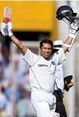 Sachin Tendulkar celebrates after passing Brian Lara’s tally of 11,953 runs to become Test cricket’s highest run-getter at Mohali on Friday