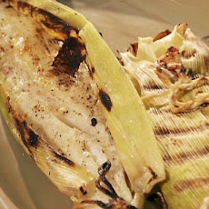 Fire Roasted Snapper Wrapped in Green Corn Husks with Charred Corn-Charred Jalapeno Salsa, and Jalapeno Pesto