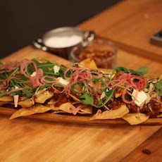 Sweet and Spicy Sausage Ragu Nachos with Pickled Onions