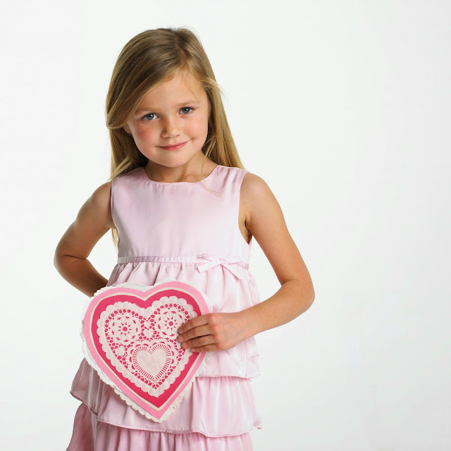 Little Girl in Pink Dress Holding Decorative Valentine's Day Heart --- Image by © Royalty-Free/Corbis