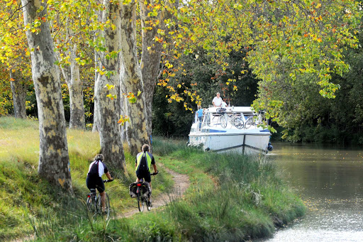 canal-du-midi-biking - Biking alongside the Canal du Midi  in the Languedoc-Roussillon region of southern France. The canal is a UNESCO World Heritage site.