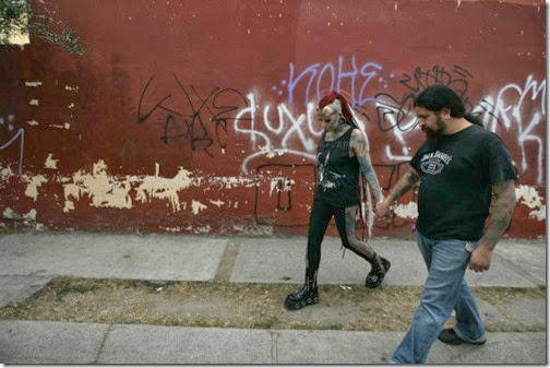Maria-Jose-Cristerna-36-a-mother-of-four-tattoo-artist-and-former-lawyer-walks-hand-in-hand-with-her-partner-David-Pena-on-their-way-to-pick-up-her-children-from-school-in-Guadalajara