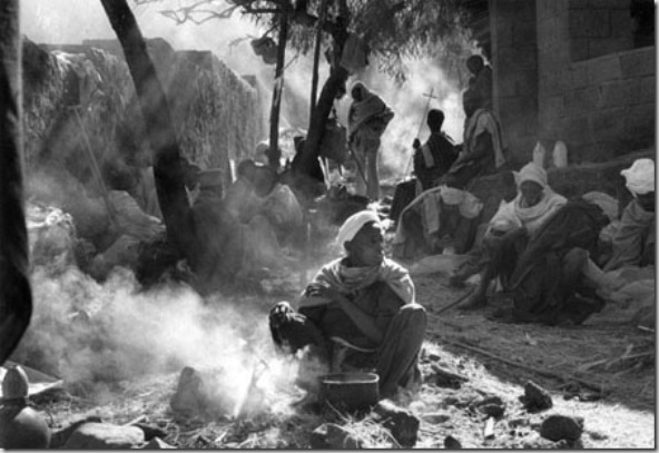 Pilgrims cooking beans during Christmas worship in the campground around Bet Madhane rock-hewn church. The basic food, always present in Amharic and Tigray houses, is the INJERA made by grain called teff, cultivate in highlands.   