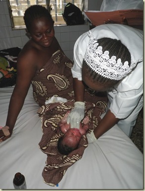 a helathy mom and baby preparing to go home- oiling the baby a form of washing in a place where clean water is scarce_sm