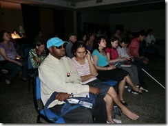 Pessoas com deficiência visual, no escurinho do cinema, assistindo ao filme Náufrago