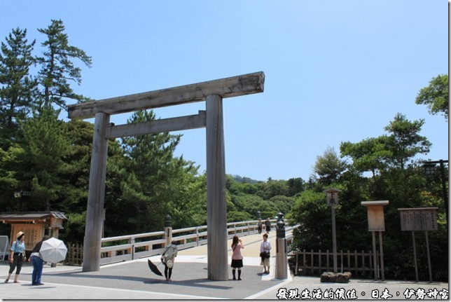 日本伊勢神宮，伊勢神宮的入口處正有日本民眾在鳥居下對著神宮的方向鞠躬表示敬意。
