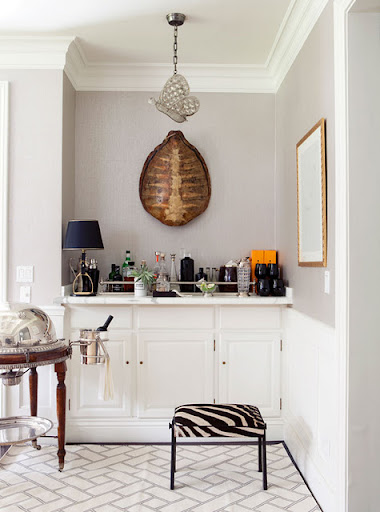 A single bright orange element draws similar hues out of a tortoise-shell wall element. The bold stripes on the zebra bench accentuate this statement. (www.designsponge.com)