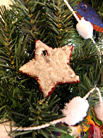glittered cinnamon ornament on wreath