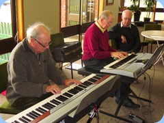 George Watt playing along with John Beales whilst Peter Brophy looks on.