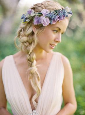 A relaxed side braid topped with a floral garland creates an angelic appearance
