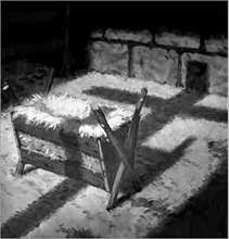 c0 shadow of the cross over a manger.