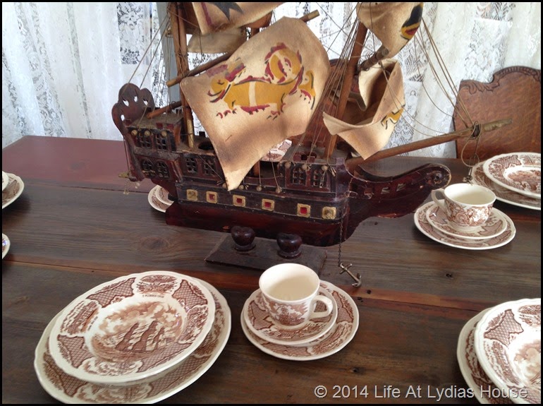 Round top table with shipping transferware and ship centerpiece via Life At Lydias House
