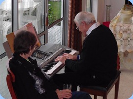 John Stent playing the PSR-910 with Secretary, Colleen Kerr, watching on with keen interest.
