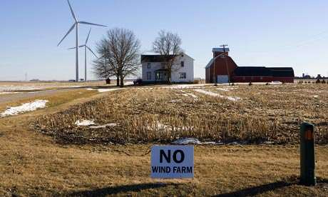 A sign near a farmhouse sited next to wind turbines reads 'NO WIND FARM'. The Donors Trust and Donors Capital Fund served as the bankers of the conservative movement over the past decade, have funded a campaign against windfarms. Photo: Alex Garcia / Getty Images