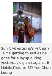 Sunlit Advertising's Anthony Jaime getting fouled as he goes for a layup during yesterday's game against B Mobile.Picture: BT/ Yee Chun Leong 