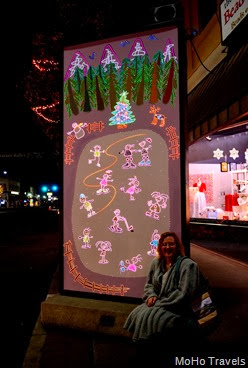 Deb with the Lighted musical Christmas panels in towntown Grants Pass
