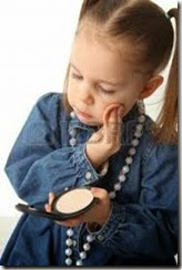 8809308-portrait-of-a-cute-little-preschool-girl-applying-makeup-and-looking-in-a-mirror