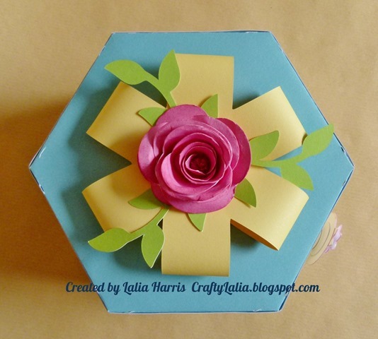 3D rolled rose and 3d paper ribbon top the Artiste exploding hexagon box.  Created by Lalia Harris