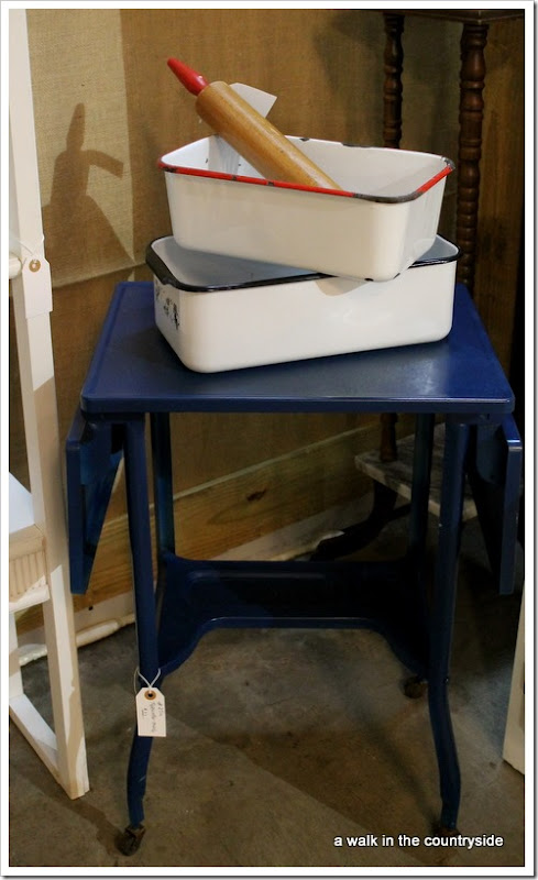 antique booth with vintage typewriter table and enamel refrigerator bins