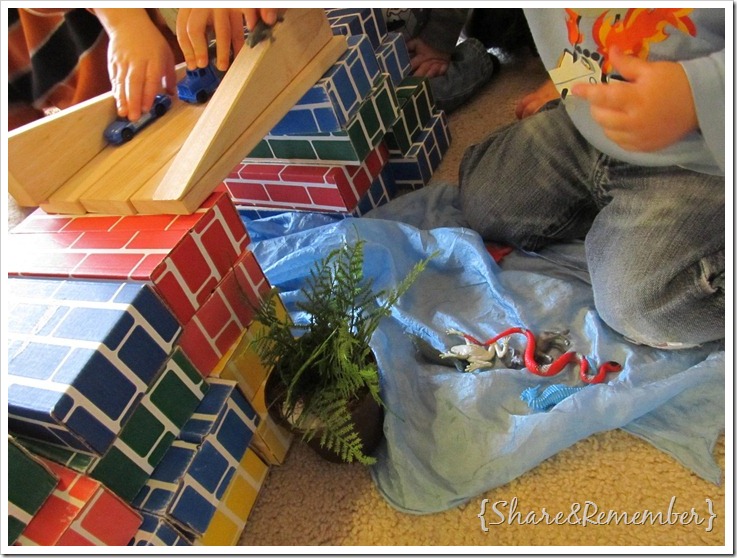 kids building a bridge with cardboard and wood blocks
