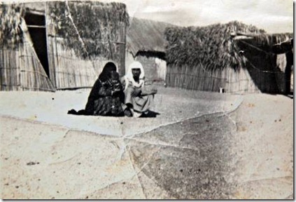 Fujairah, Al Faseel neighbourhood. UAE. 1970 (date unknown) Photo shows Abdullah bin Khaten (right) and his wife Mozah Mohammed holding her grandaughter Mariam Al Kaabi. They are sitting outside their home made of areesh (date palm) The photograph was taken by a British man, possibly a tourist who was touring the Gulf at the time.  Courtesy of Bin Kateem family. 

Ramadan Feature for Weekender