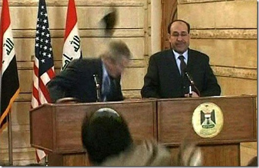 In this image from APTN video, an man throws a shoe at President George W. Bush during a news conference with Iraq Prime Minister Nouri al-Maliki on Sunday, Dec. 14, 2008, in Baghdad. The man threw two shoes at Bush, one after another. Bush ducked both throws, and neither man was hit. (AP Photo/APTN)