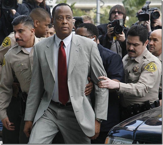 Conrad Murray...** FOR USE AS DESIRED, YEAR END PHOTOS ** FILE -In this Feb. 8, 2010 file photo, Conrad Murray, Michael Jackson's doctor, is escorted by Los Angeles County Sheriffs deputies as he arrives at the Airport Courthouse to face charges of involuntary manslaughter in the singer's death in Los Angeles. (AP Photo/Jason Redmond, File)