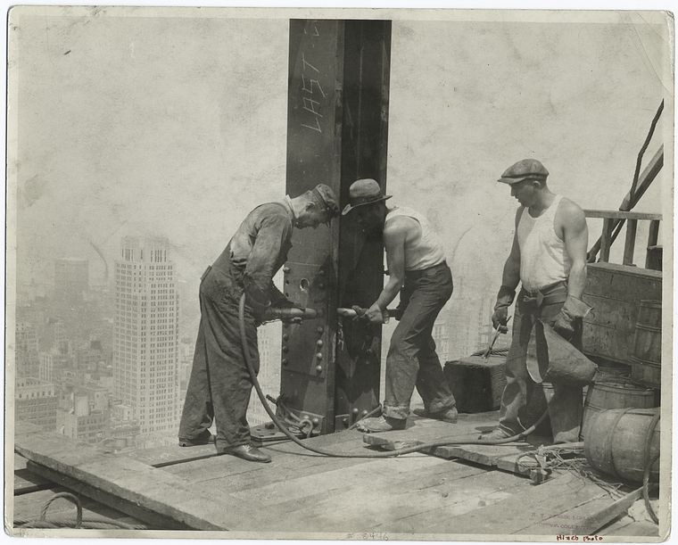 [Three-workers-securing-a-rivet-19313.jpg]