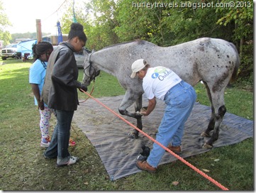 Sally demonstrates cleaning her horse's hoof.