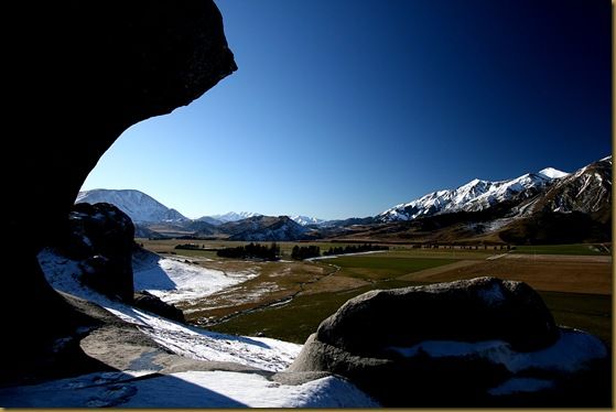 boulders snow mountains sky