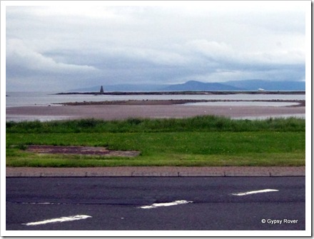 Isle of Arran hidden in cloud with a ferry crossing to Ardrossan. We assume the pinnacle is a light house.
