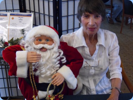 Role reversal! Santa Claus sitting on Colleen Kerr's knee.