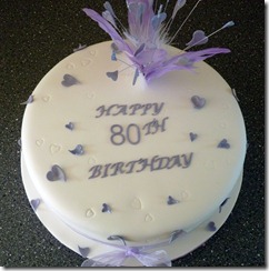 80th birthday cake with lilac feathers