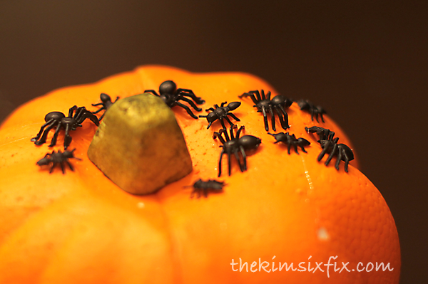 Glue fake spiders on pumpkin