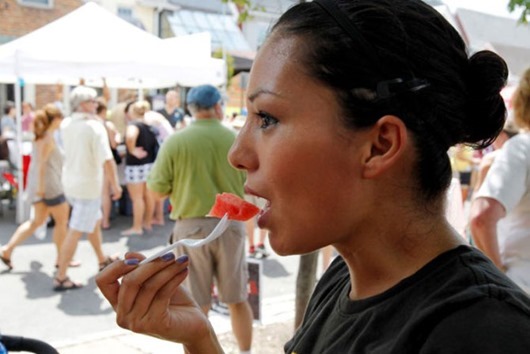 Patty Valmores of Richmond enjoyed a bite of watermelon in the shade during the annual Carytown Watermelon Festival, Sunday, August 5, 2012.
