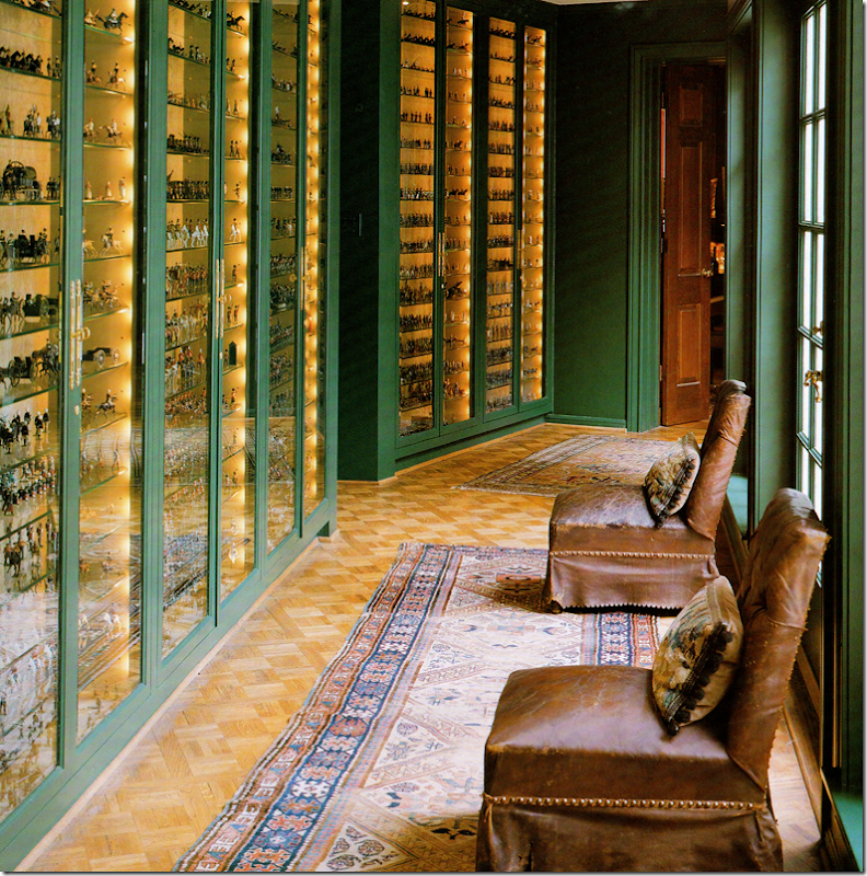 Hallway to family room in Jane Moore's Georgian home in Houston. The cases contain a collection of toy soldiers.