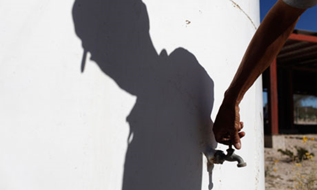 A man turns on the tap of an empty water tank in the Mexican state of Nuevo Leon. Tomas Bravo / Reuters