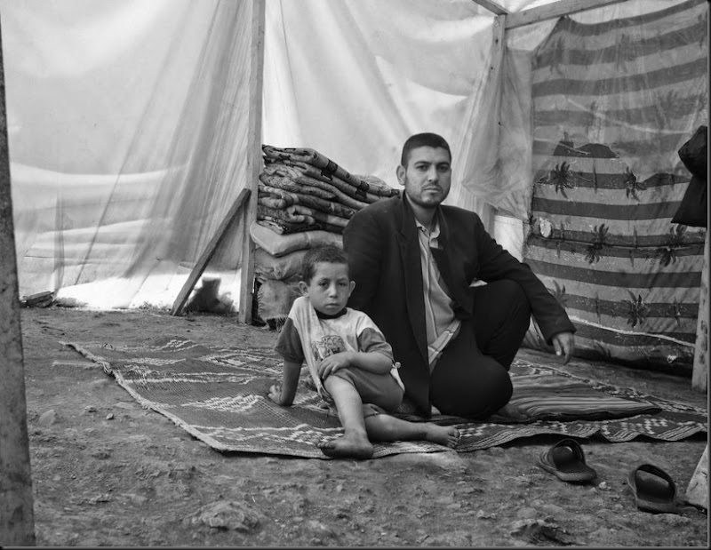 A father and son inside their tent in the Bekaa Valley after they fled from the Syria. (Moises Saman/Magnum Photos for Save the Children)