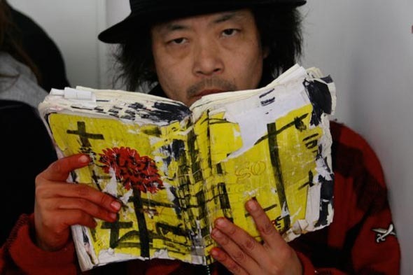 Sion Sono holding the shooting script for Love Exposure.