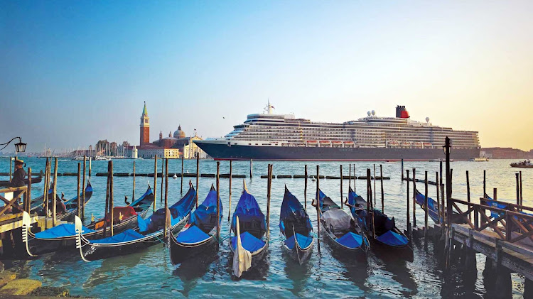 Queen Elizabeth glides past St. Mark's Square in Venice, one of the memorable destinations on a Cunard cruise.