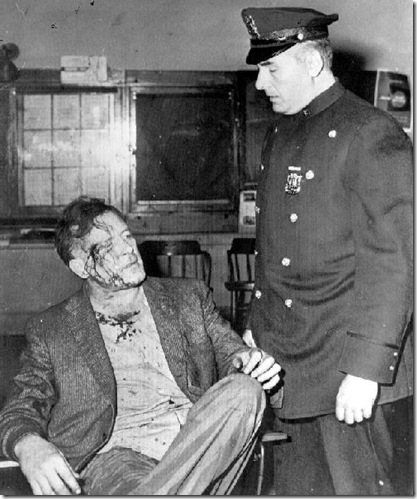Tierney Jailed After Scuffle  New York -- Patrolman Louis Romano questions former movie actor Lawrence Tierney in the West 54th Street Police Station early today. Tierney was arrested after a bruising battle with Romano and another policeman on Sixth Avenue after they had ejected him from a bar. All three were given treatment at a hospital and released. (1958)
