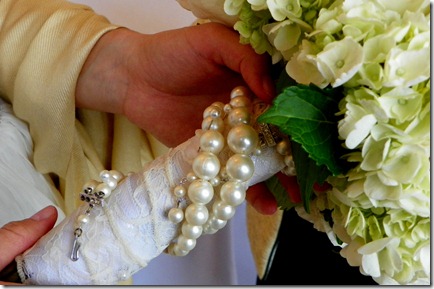 Mama Trudy's pearls wrapped around the bride's bouquet.