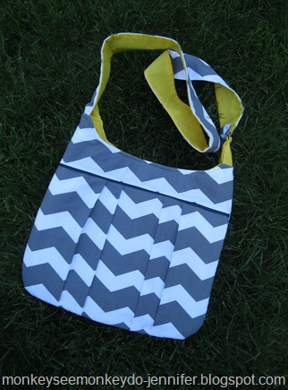 gray and white chevron pleated bag with yellow interior