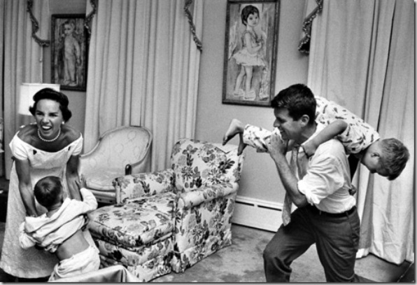 Bobby Kennedy, chief counsel of Sen. Comm. on Labor & Management, carrying his pajama clad young son Joe over his shoulder like a sack of potatoes as his wife Ethel roars w. laughter while trying to fend off another son during bedtime roughhouse, at home.  (Photo by Paul Schutzer//Time Life Pictures/Getty Images)