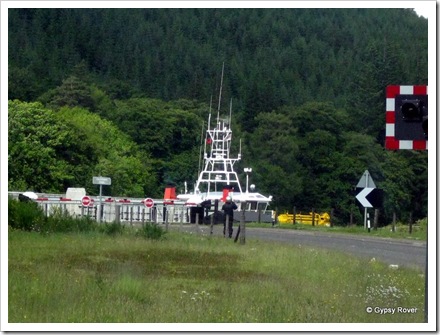 A tug passing through the swing bridge on the Caledonian Canal  at Loch Oich.