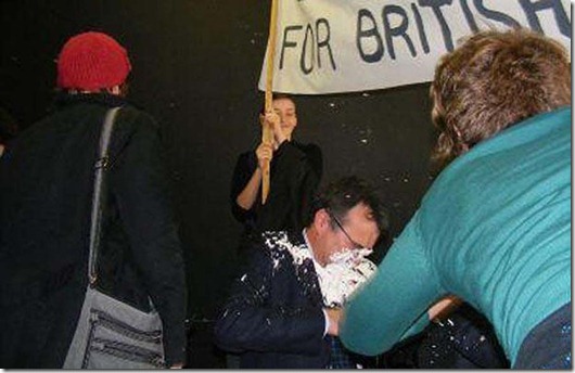Immigration Minister Phil Woolas was hit with a custard pie at Manchester University in a protest against his plan to eject more asylum seekers. <br />mail_sender Pictures@mercurypress.co.uk <br />mail_subject Woolas <br />mail_date Fri, 24 Oct 2008 18:32:01 +0100 (BST) <br />mail_body <br /><br />Mercury Press Agency Ltd, Liverpool<br /><br />Telephone 0151 709 6707<br /><br />Immigration Minister Phil Woolas was hit with a custard pie at Manchester University in a protest against his plan to eject more asylum seekers.<br /><br /><br /><br />The Labour MP was speaking at a debate on environmental issues when a female member of the crowd raced onto the stage and slammed a pie in his face.<br /><br /><br /><br />The Oldham East and Saddleworth MP looked stunned and was taken away and cleaned up - but he returned a short time later to continue the debate.<br /><br /><br /><br />Mr Woolas hit the headlines earlier this week after making a string of controversial remarks about his new role.<br /><br /><br /><br />He appeared to call for a limit on immigration to keep Britain's population under 70 million and criticised the failure to spend