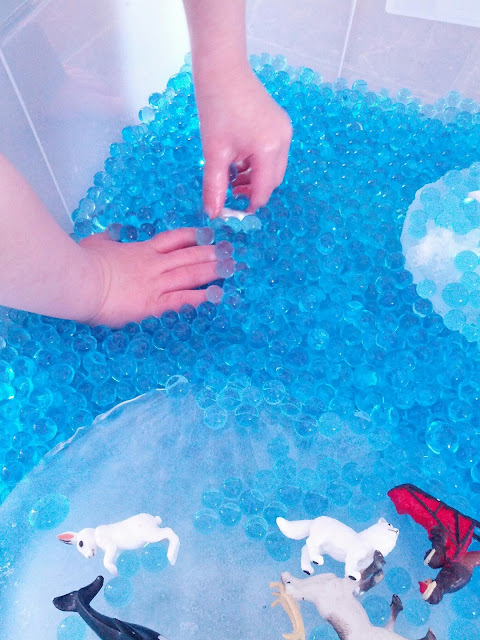 Blue water beads in an arctic sensory bin