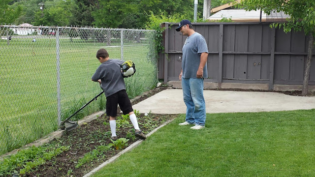 David Learning to Use the Weed Whacker in Starr's Backyard